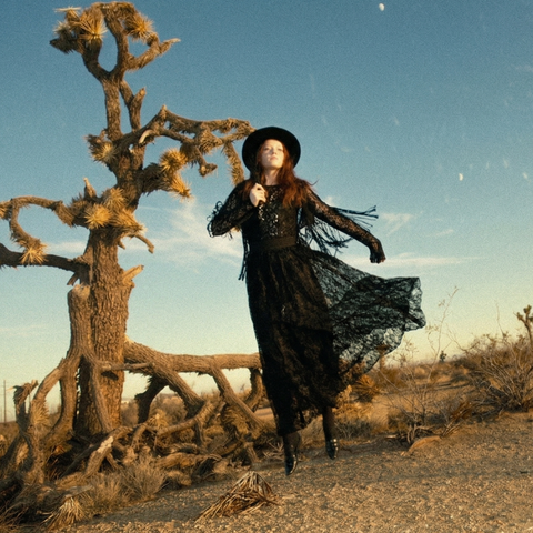 A person practicing mindfulness in a desert landscape to trigger a creative flow state, reflecting the serene Favajava ritual.